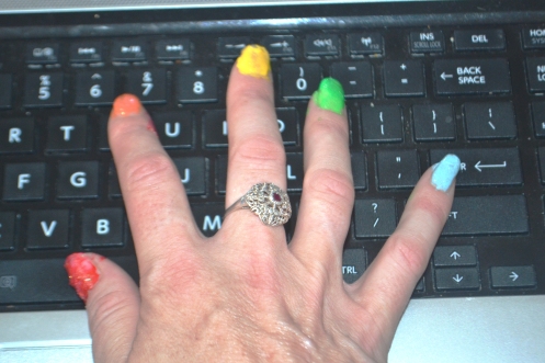 Tapping away with rainbow nails. 
