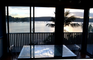 Sunseting over Pittwater with the cloudy sky reflected on the dining table.